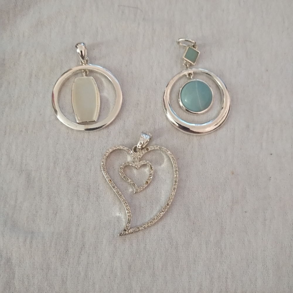 3 silver toned pendants